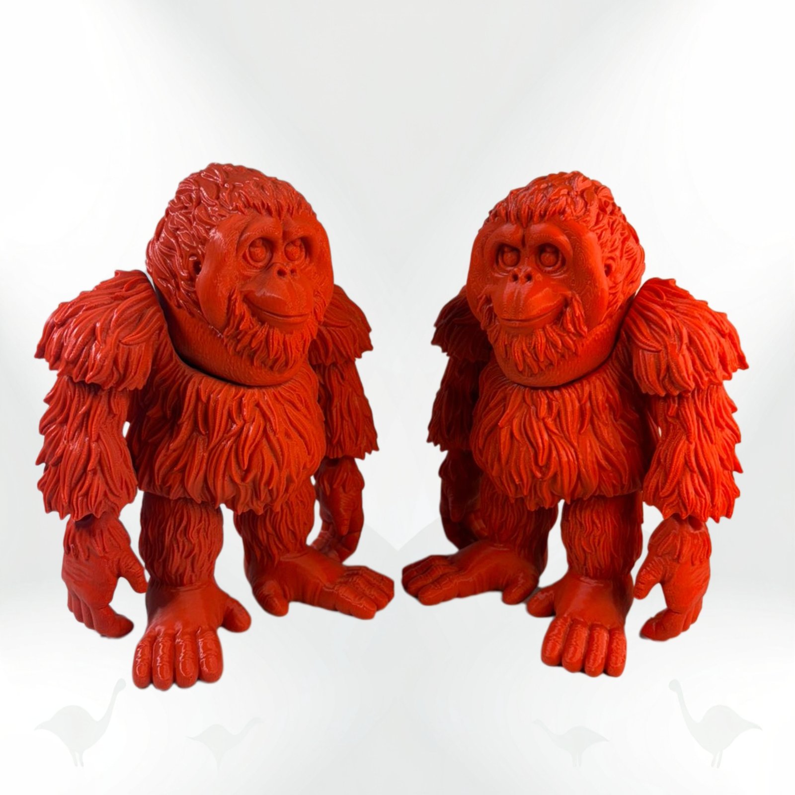 Two collectible Orangutan figurines, bright orange with detailed fur texture. Two collectible Orangutan figurines, bright orange with detailed fur texture.