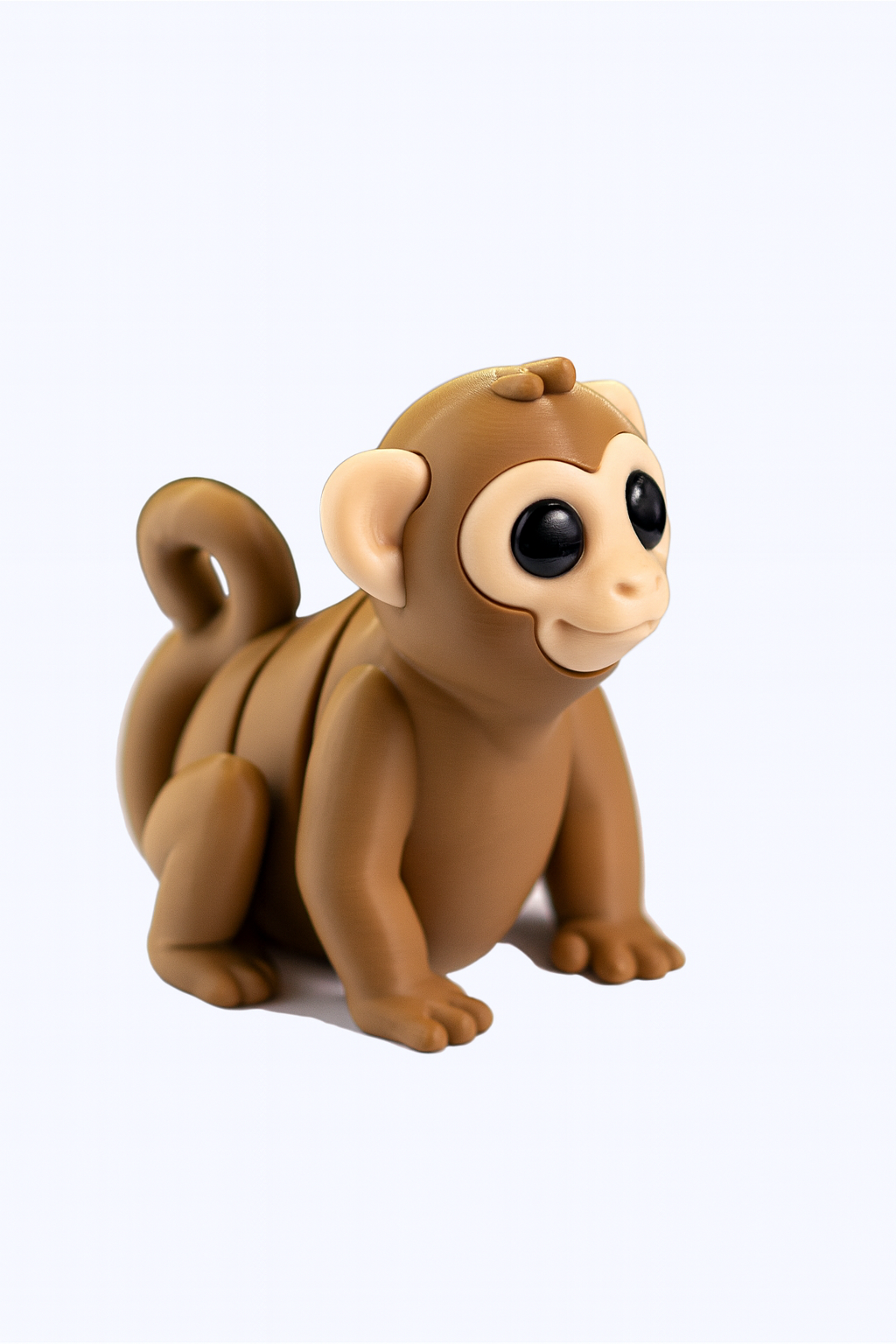 Brown Monkey toy figurine with large black eyes, a smiling expression, and a curled tail. A great collectible or gift.