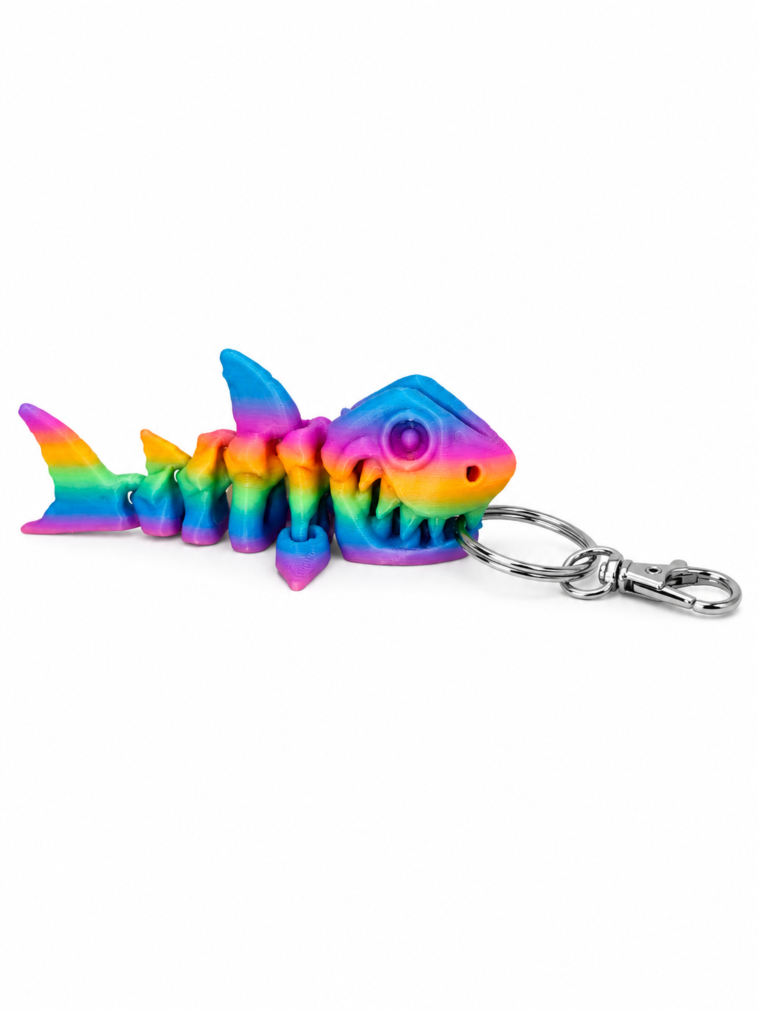 ChatGPT Image Jul 17 2026 10_31_32 AM Rainbow-colored 3D printed articulated shark skeleton keychain with metal clasp.