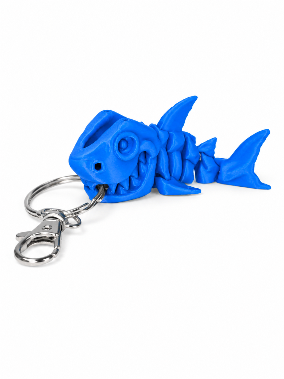 ChatGPT Image Jul 17 2026 10_34_52 AM Blue plastic shark skeleton keyring with a silver lobster clasp and keyring.
