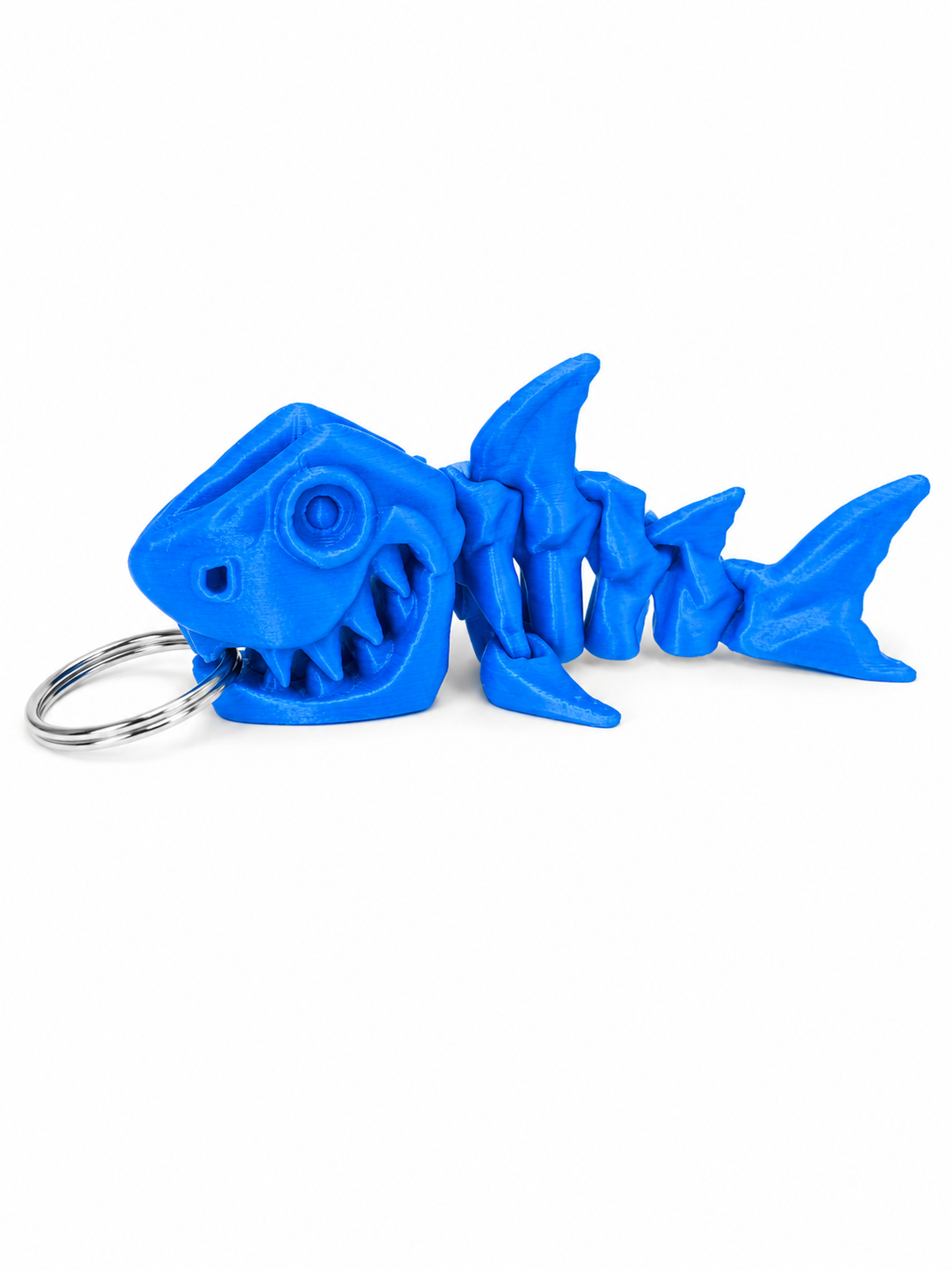 ChatGPT Image Jul 17 2026 11_06_29 AM Blue 3D printed articulated shark skeleton keyring with a metal ring.