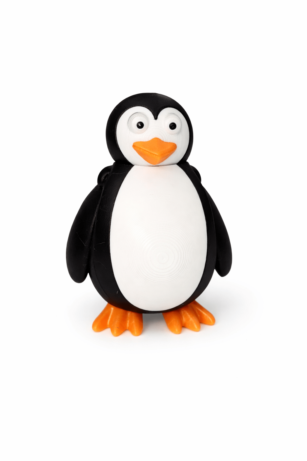 ChatGPT Image Apr 1 2026 10_38_32 AM Penguin figurine with black and white body, orange beak and feet.