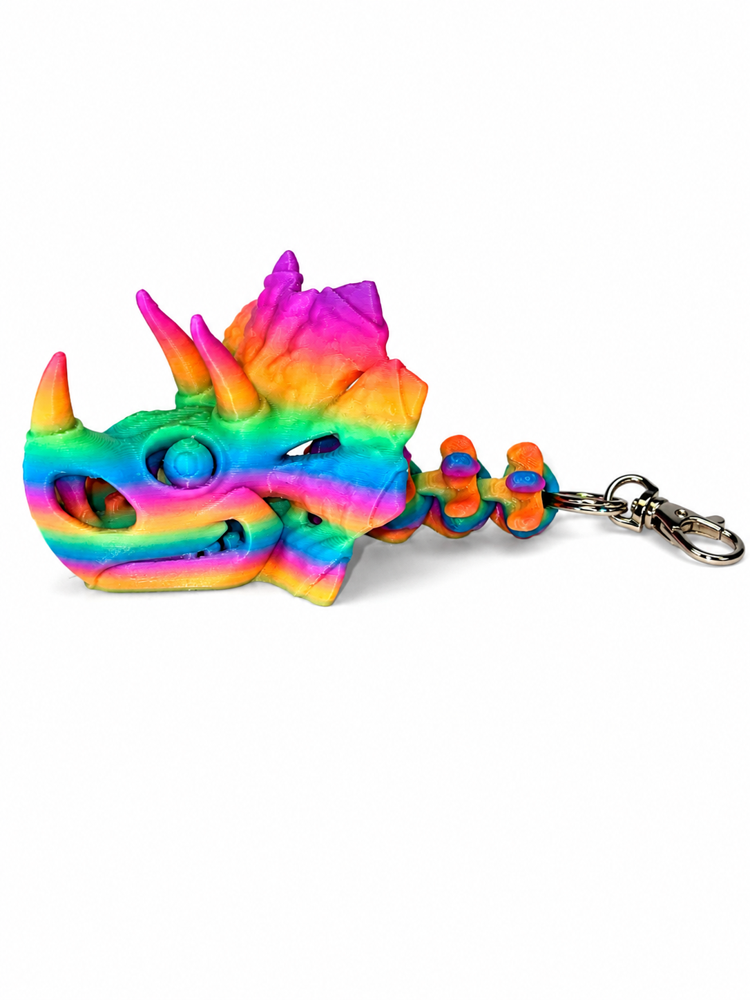 ChatGPT Image Jul 16 2026 11_17_58 AM Rainbow gradient 3D printed Triceratops skull keychain with articulated neck.