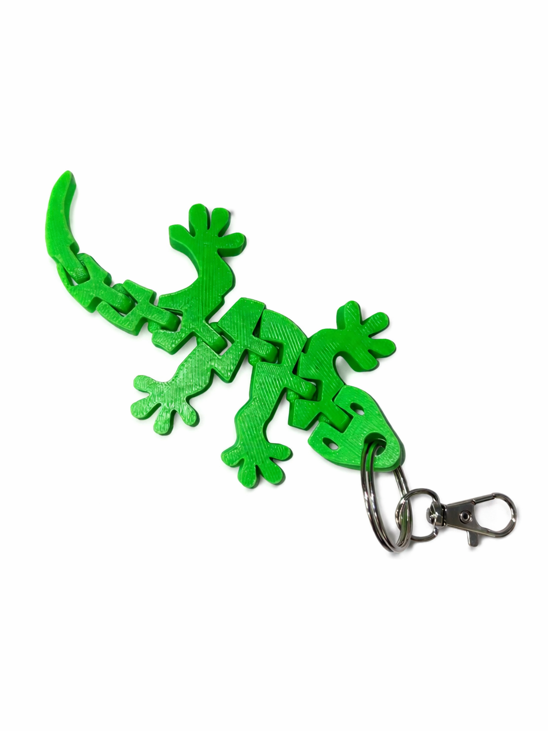 Green Gecko White Bg 2 Green Gecko Keyring: Articulated plastic gecko keychain with metal ring and clip.